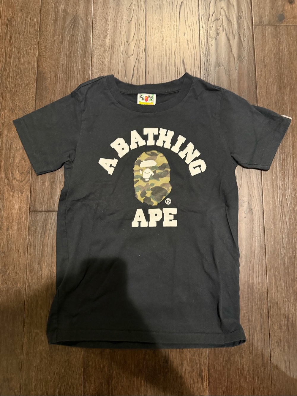 Bape Kids Black Tee with Green Camo Ape Logo